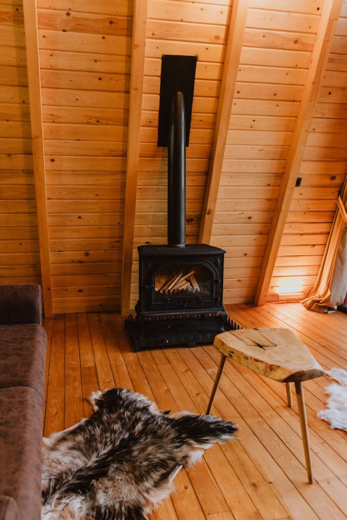 Warm wooden cabin interior with stove and rustic decor for a cozy ambiance.